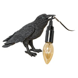 Crow Holding Bulb Lamp - Turned Off